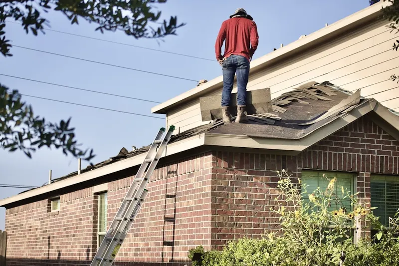 Professional roofer working on a residential roof in Ludlam